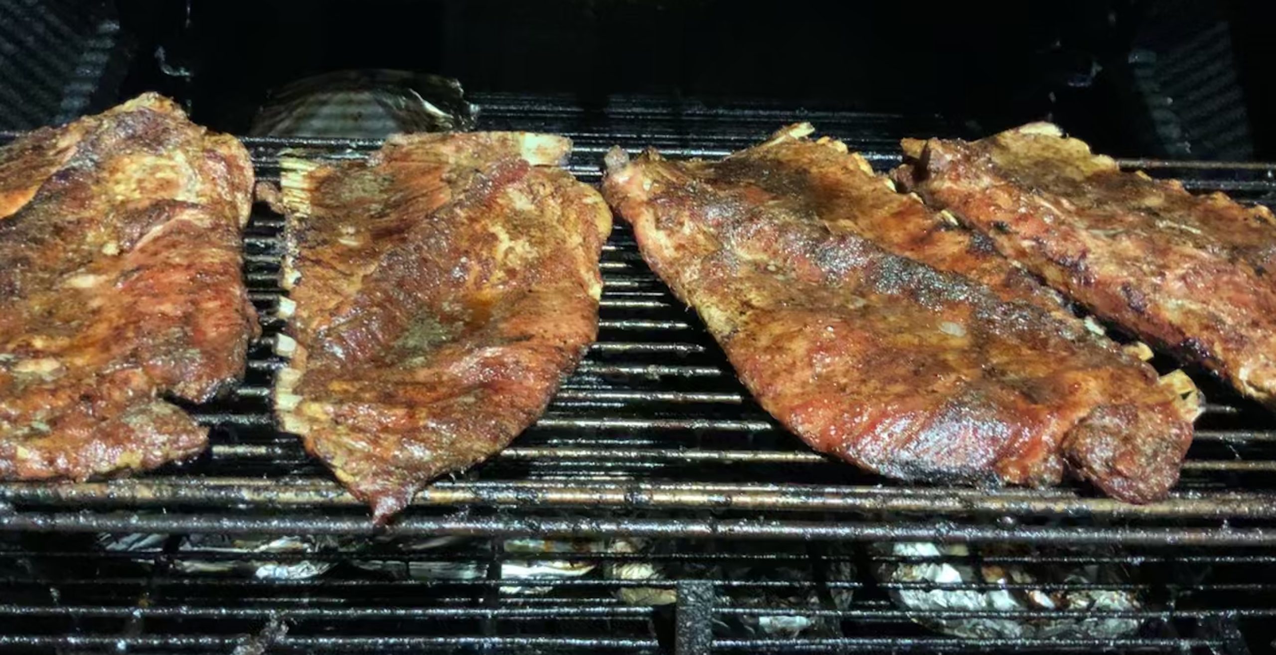 Pork Ribs smoking on the grates